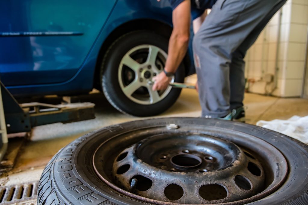 An mechanic works on a tire.